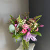 This beautiful flower arrangement of fresh mixed seasonal blooms is made by