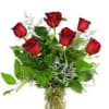 Bouquet of red roses with greenery in a clear vase