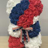 Red, white, and blue rose teddy bear with a patriotic ribbon