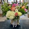 Mixed bouquet in a white hatbox with pink, peach, and white blooms