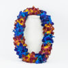 Colorful flower lei draped over a white mannequin bust