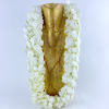White flower lei draped over a gold decorative object
