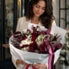 A sophisticated luxury bouquet featuring deep burgundy blooms paired with crisp white