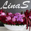A luxurious arrangement of soft pink peonies, elegant pink Phalaenopsis orchids, and