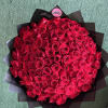 Large bouquet of red roses wrapped in black paper