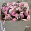 A lush peony bloom with soft, layered petals that unfold in elegant