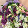 A Large wrapped bouquet with 40 purple and white stems