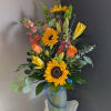 This beautiful flower arrangement of fresh mixed seasonal blooms is made by