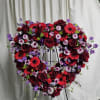 Full open heart with Roses, Gerbera daisies, mixed Carnations, light additions of