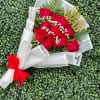 Vivid red roses take center stage in this Congrats Grad bouquet, making