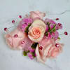 A cluster of petite blush pink spray roses accented with tiny pink
