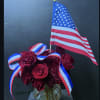 Red roses, flag,  ribbon.