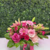 A joyful cluster of pink roses, gerbera daisies, carnations, alstroemeria and lily