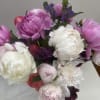 One dozen (12 stems) of peonies in a variety of colors, presented