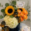 Luxury graduation flower arrangement handcrafted with fresh sunflowers, hydrangeas, ranunculus and premium