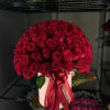 Large bouquet of red roses tied with a satin ribbon in a pale box