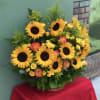 Basket arrangement of sunflowers and yellow-pink roses