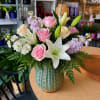 Soft, romantic tones of pink, cream, and lavender make this flower arrangement