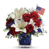 Bright, bold red roses paired with large white lilies and clusters of