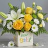 Soft white lilies and sunny yellow roses create an uplifting welcome in