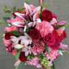 Bouquet of pink and red roses, lilies, and carnations