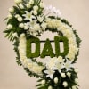 A dignified memorial wreath crafted in white and green for a father