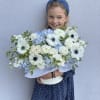 Girl holding a large bouquet of white and pale blue flowers