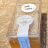 Plastic container of comb honey with labels on a countertop