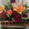 Mixed bouquet in a rustic wooden box with red roses and orange lilies