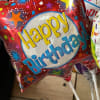 Red birthday balloon with colorful stars and 