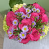 Vivid hot pink roses take center stage in this romantic flower arrangement