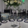 A towering white centerpiece designed for weddings or upscale receptions, this event
