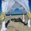 This tied wedding arrangement pairs pale pink roses and creamy white blooms
