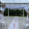 This tied wedding ceremony arrangement pairs white flowers with deep pink and