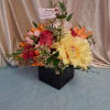 A lush cluster of pink roses and vibrant orange lilies makes this