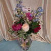 Lush pink peonies and soft peach roses combine into a romantic birthday