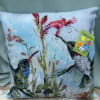 A beautiful pillow with a hummingbird and flowery pattern