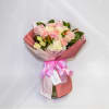 Pink and white bouquet of roses and carnations in wrapping with a ribbon