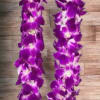 Purple orchid lei on a wood surface
