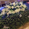 A elegant centerpiece that reads like a lush garden across your event