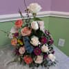Soft blush and white roses meet coral carnations and purple daisy mums