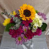 A bold golden sunflower steals the show in this wild mix bouquet