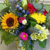 Bold yellow sunflowers and golden chrysanthemums set a sunny, celebratory tone in