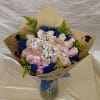 Pale pink roses gather in a soft, romantic cluster centered on a