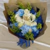Crisp blue and white roses paired with pale blue carnations create a