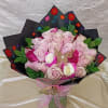 A tightly packed spray of two dozen pink roses creates an immediate