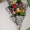 Bright pink roses and trumpet-shaped white lilies take center stage in this