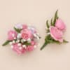 Soft pink roses arranged in a compact, rounded corsage set create a