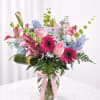 This crystal vase arrangement has a mix of blooms, representing a mother's