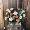 Peach and blush roses with dahlias and ranunculus in a rustic wooden box centerpiece